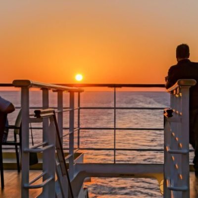 rear-view-men-traveling-boat-against-orange-sky_1048944-30248452