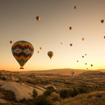 set-colored-balloons-flying-ground-cappadocia-turkey_181624-20938